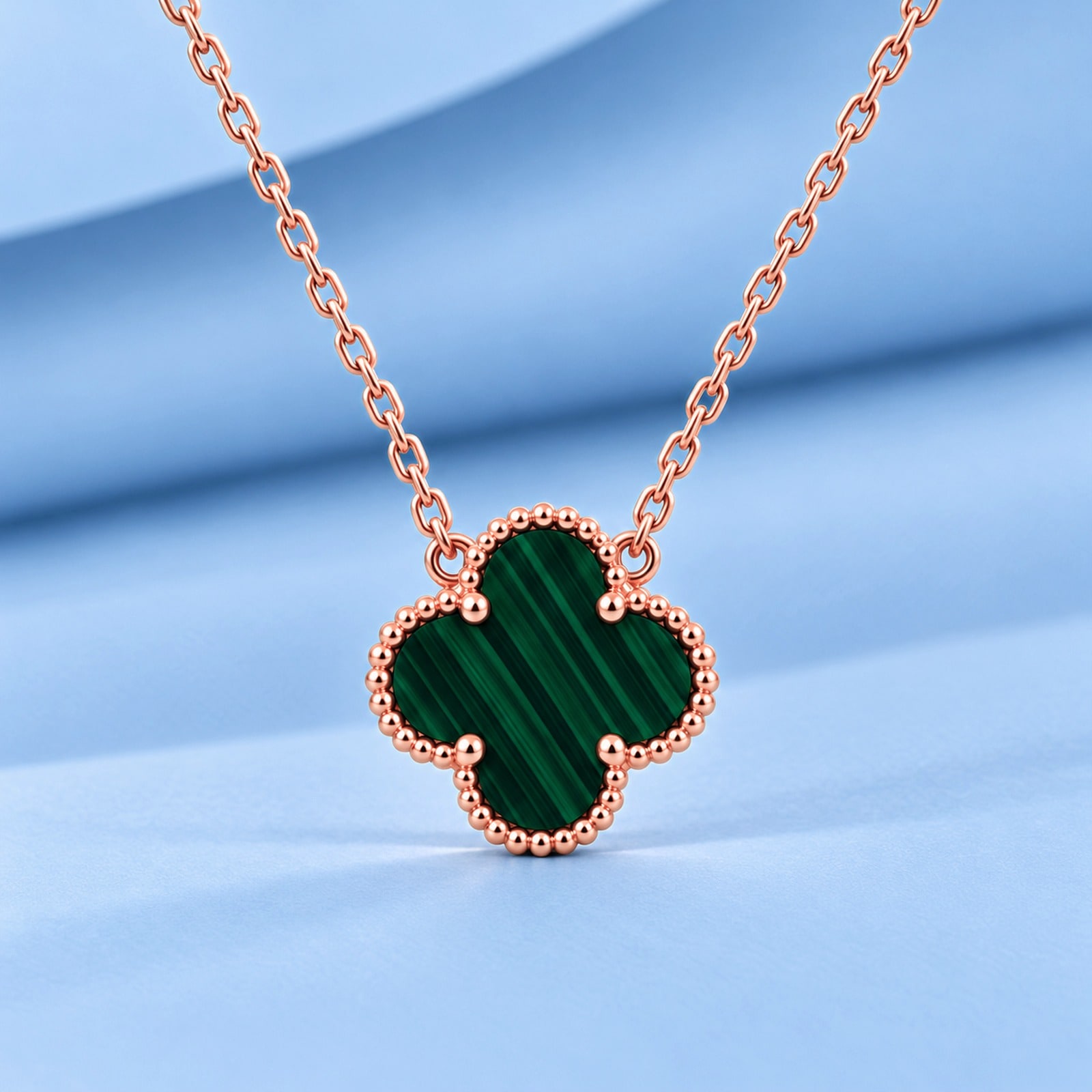 Gold necklace with malachite in the style of van cleef