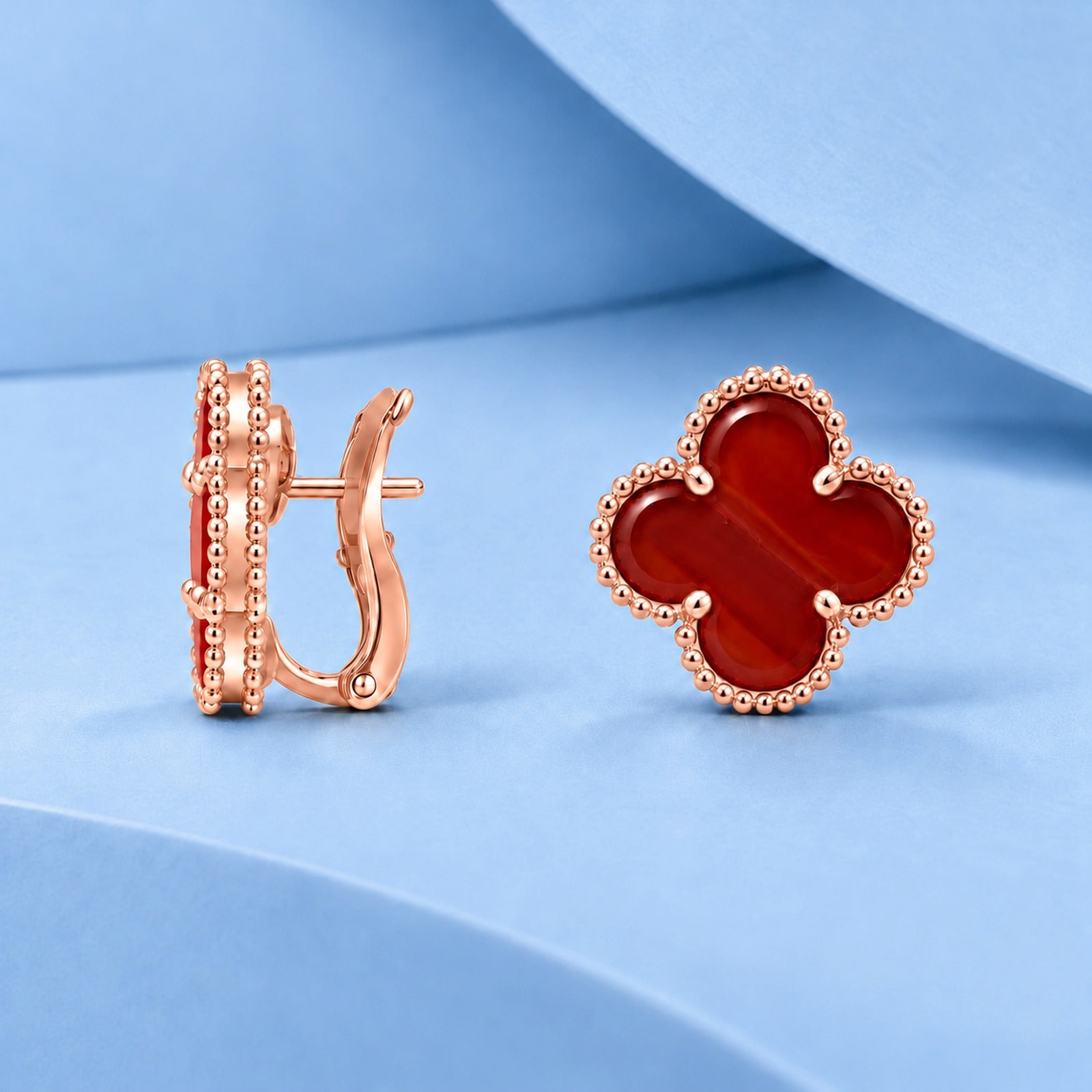 Gold earrings with carnelian in the style of van cleef