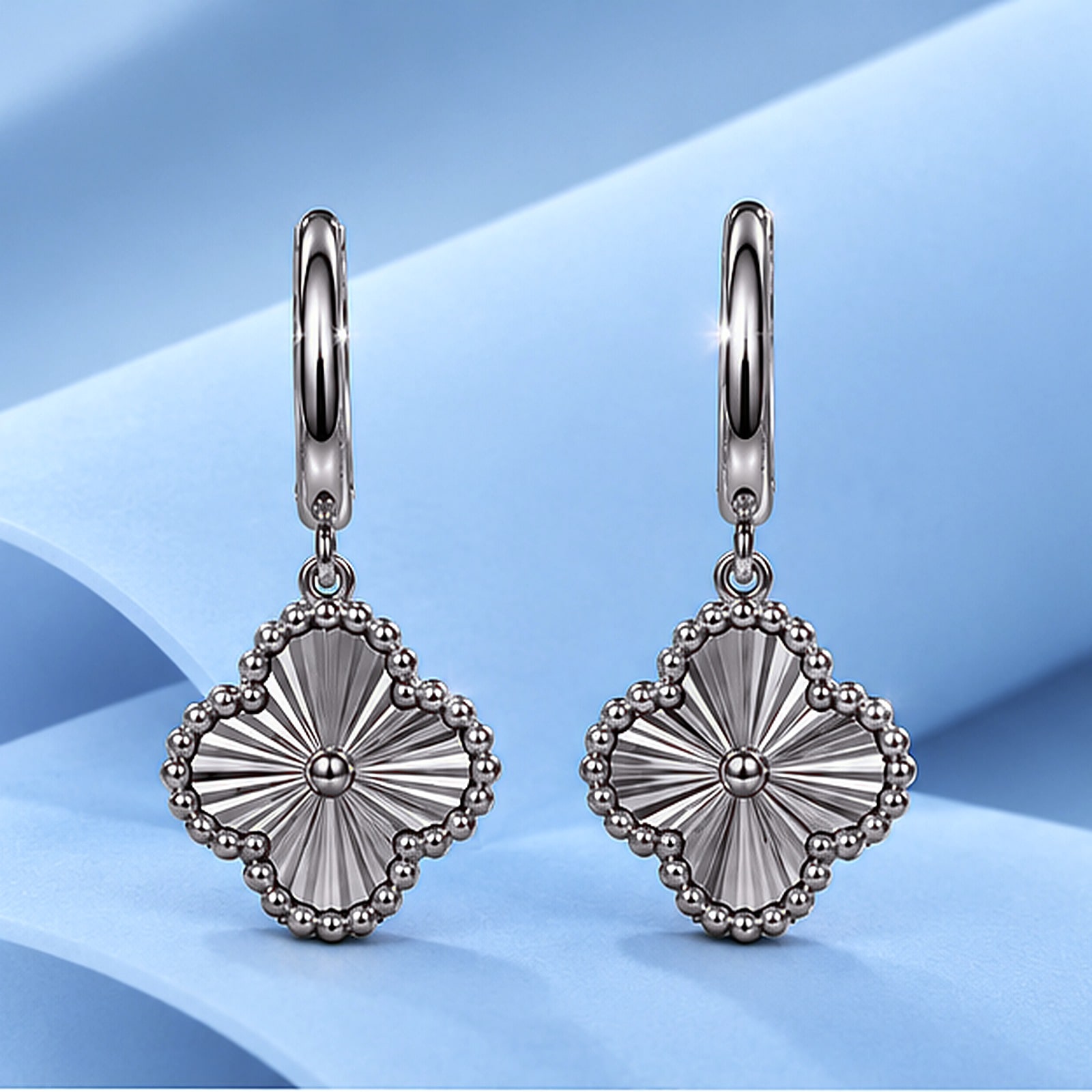 Gold earrings in the style of van cleef