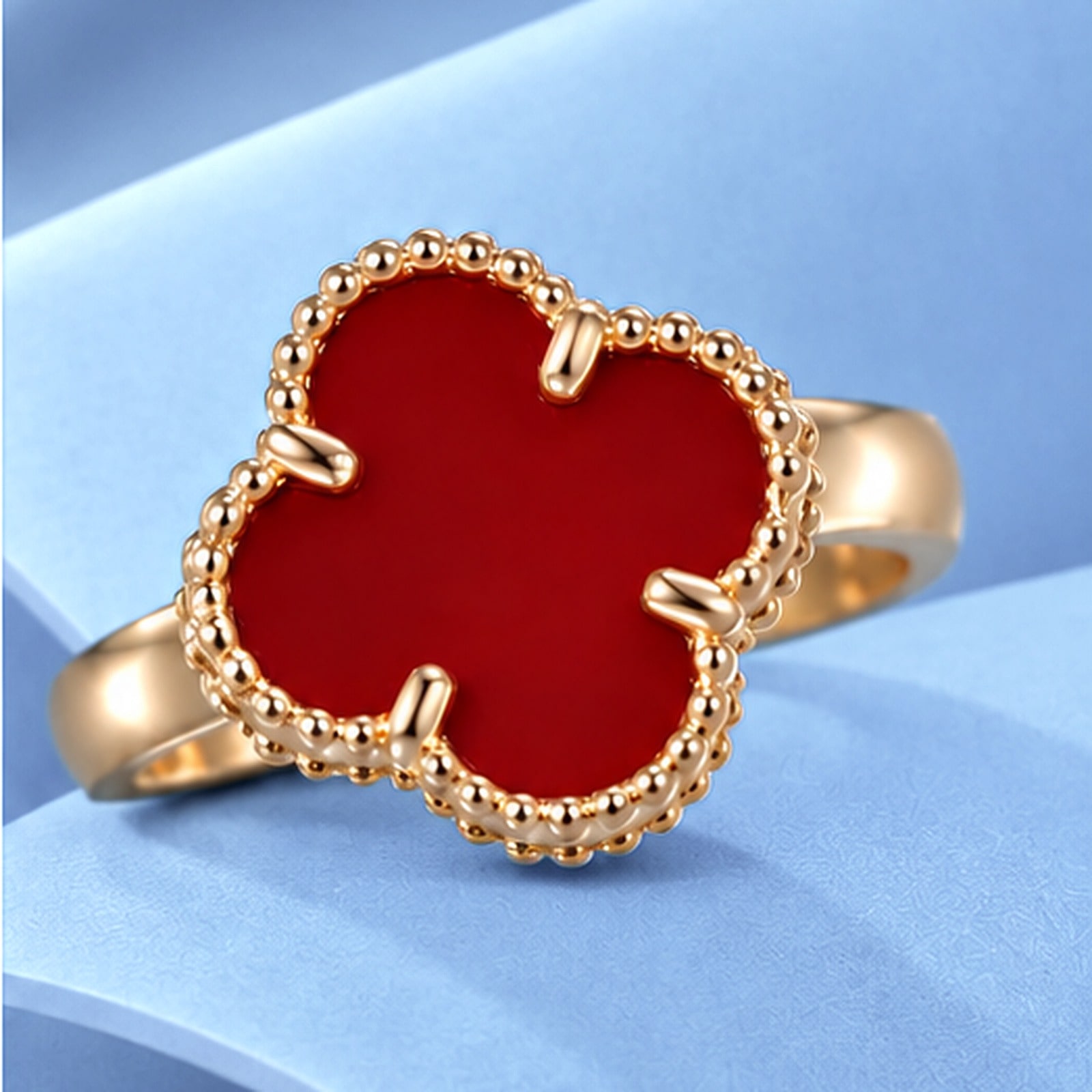 Gold ring with carnelian in the style of van cleef