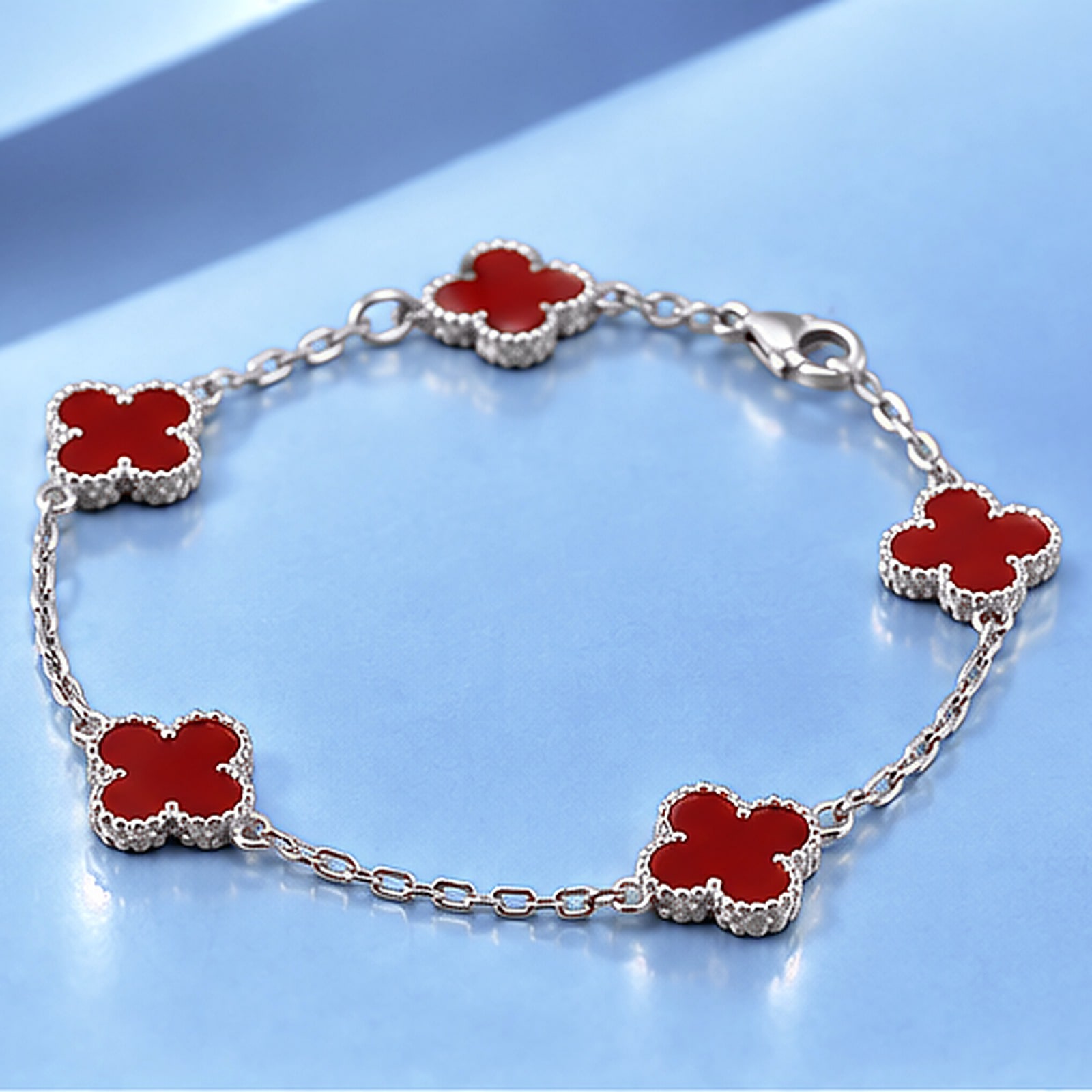 Gold bracelet with carnelian in the style of van cleef