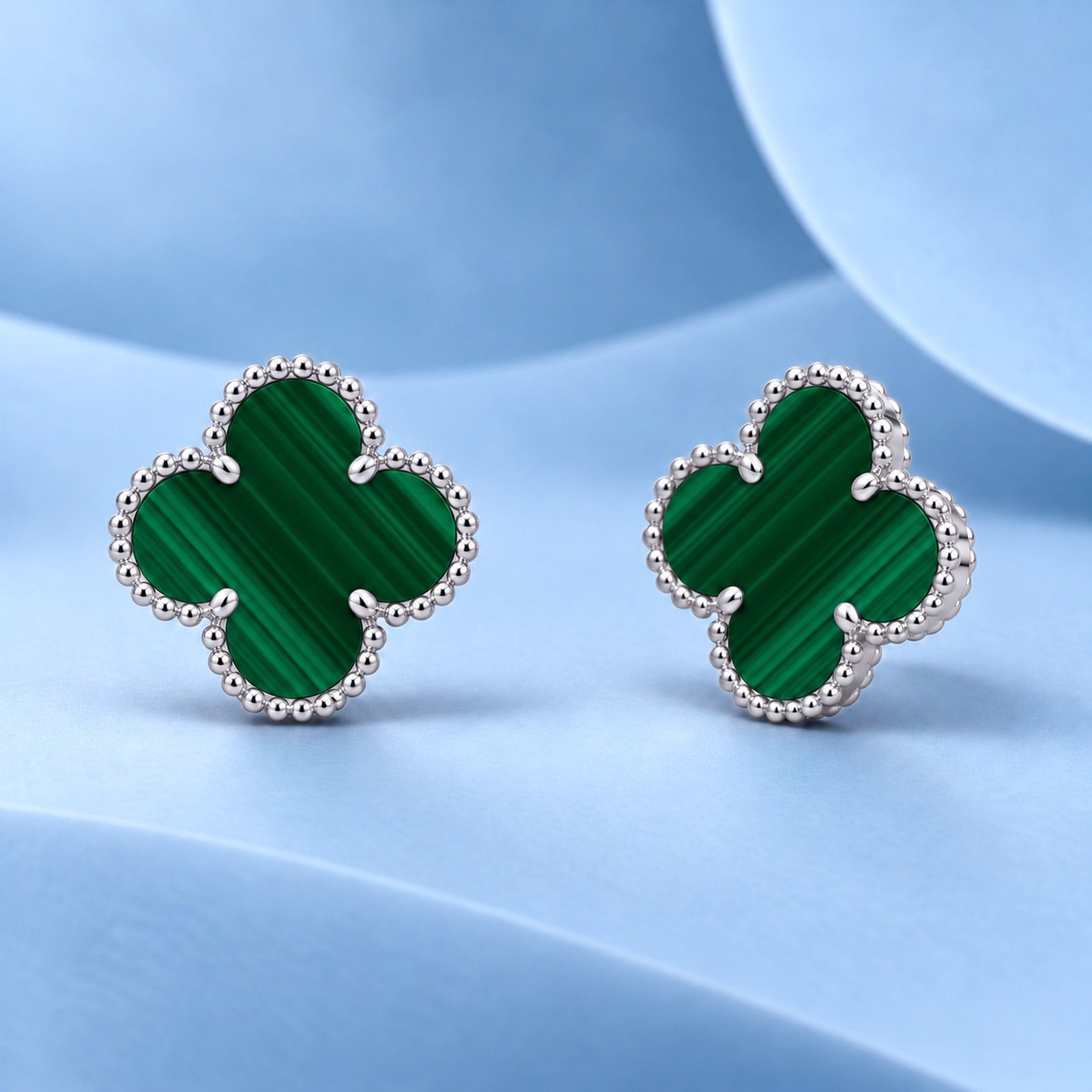 Gold earrings with malachite in the style of van cleef