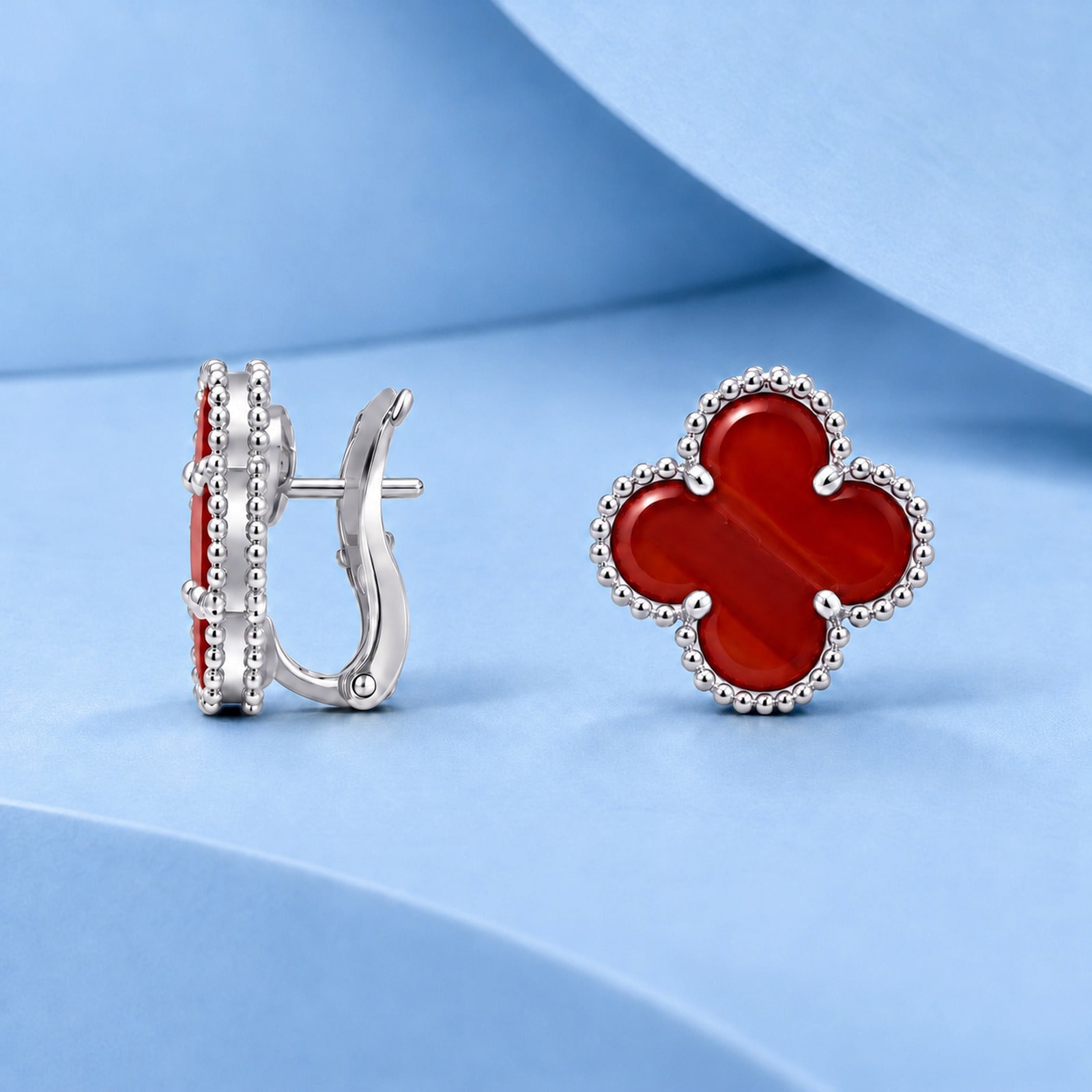 Gold earrings with carnelian in the style of van cleef