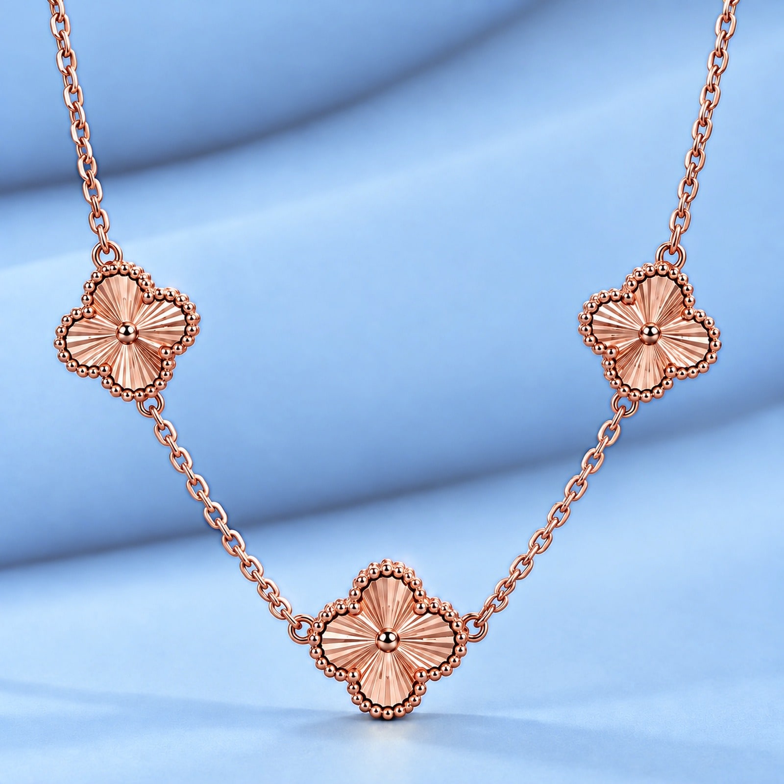 Gold necklace in the style of van cleef