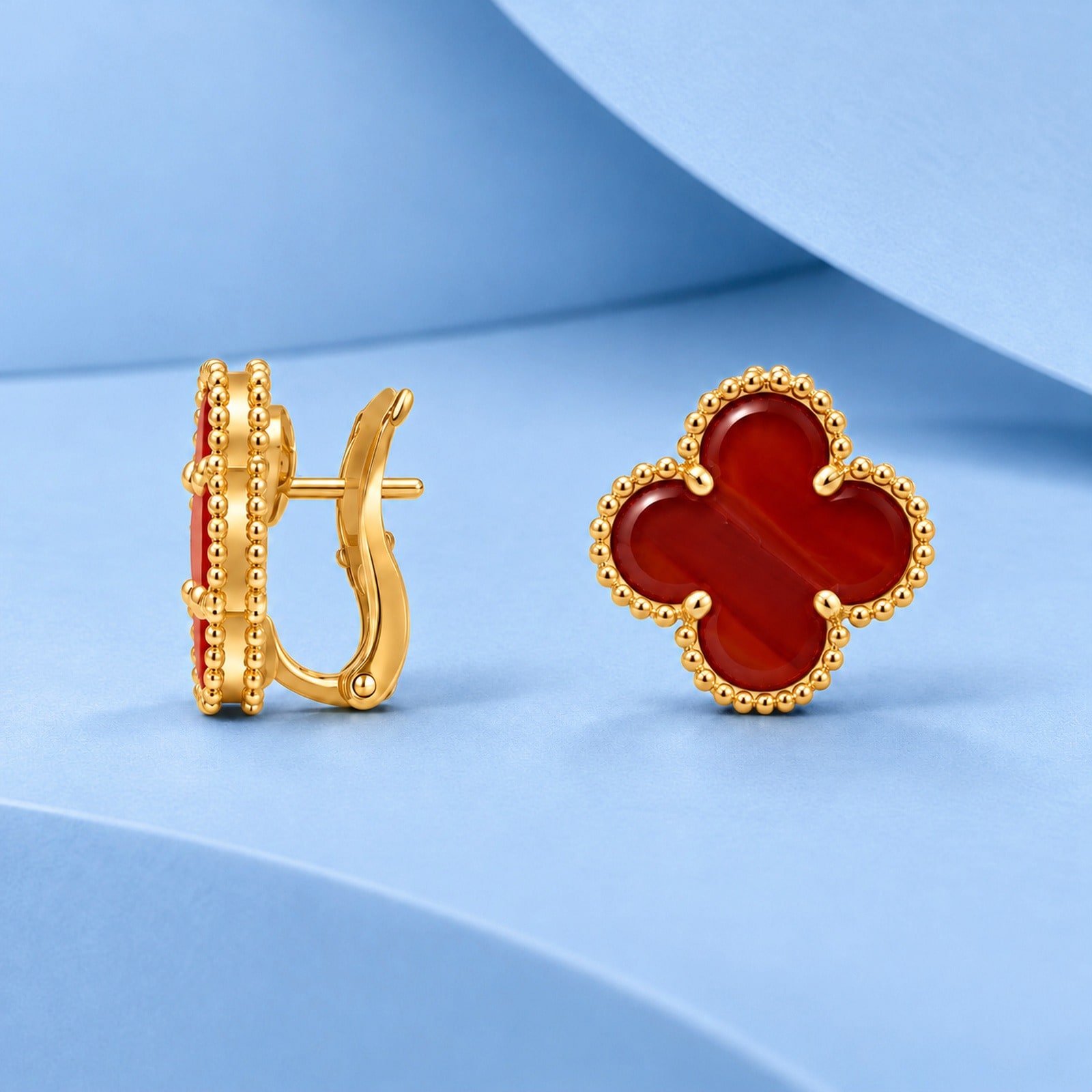 Gold earrings with carnelian in the style of van cleef