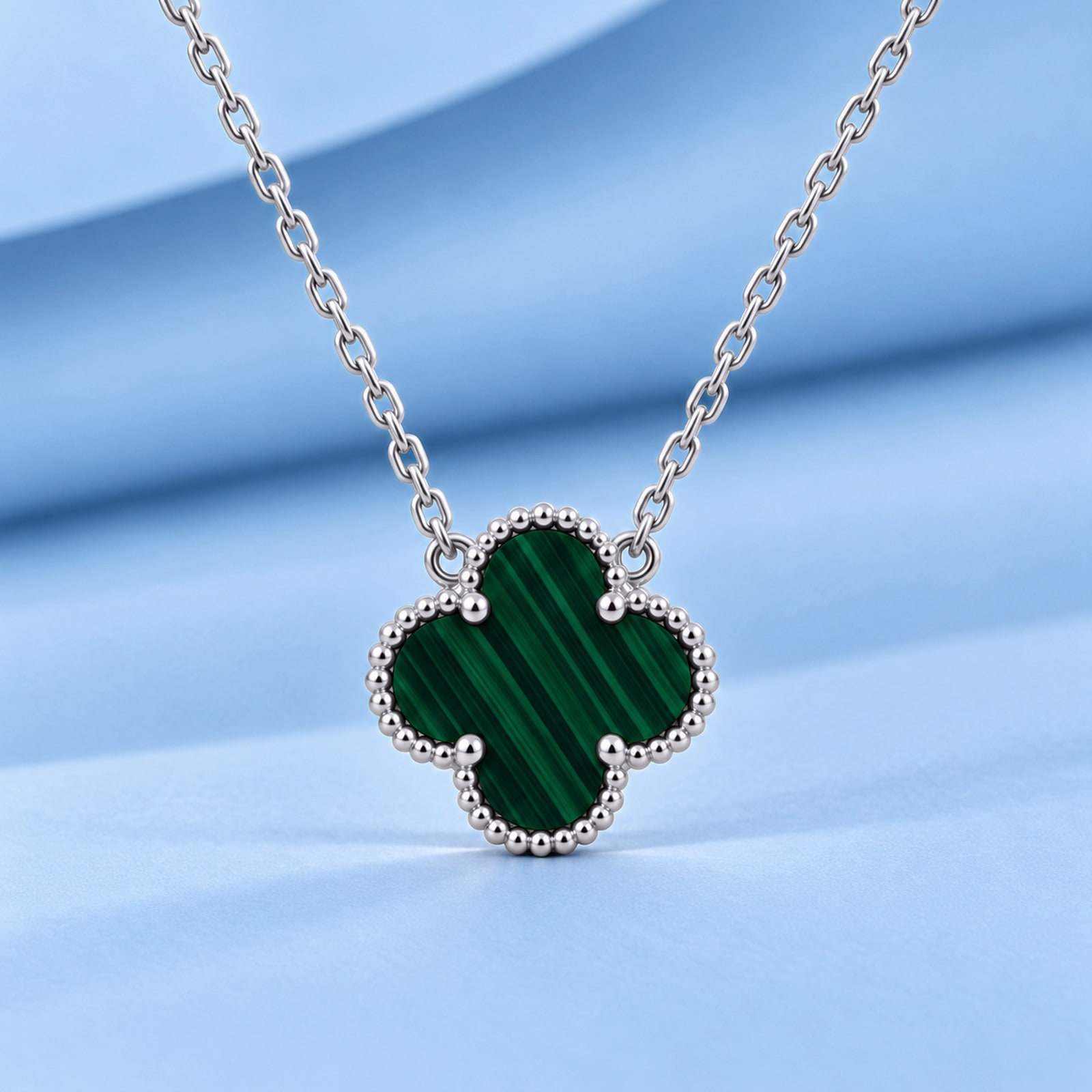 Gold necklace with malachite in the style of van cleef