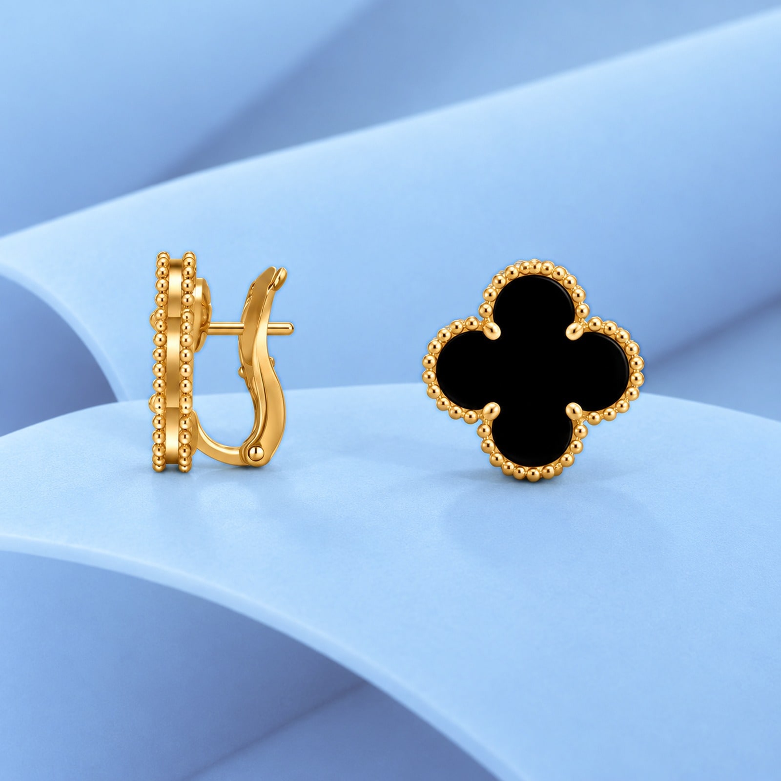 Gold earrings with onyx in the style of van cleef