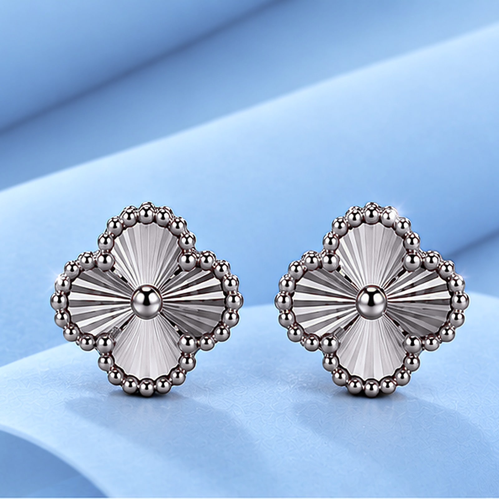 Gold earrings in the style of van cleef