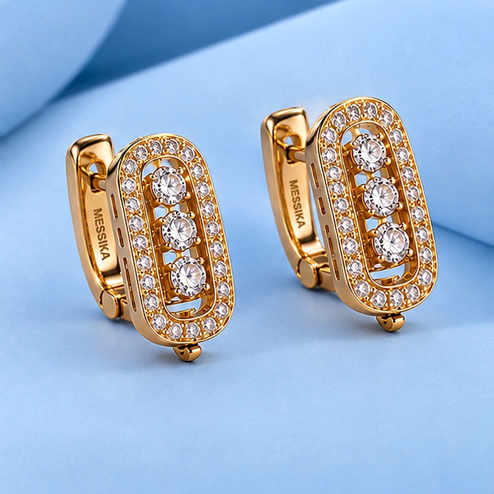Gold earrings with diamonds in the style of messika