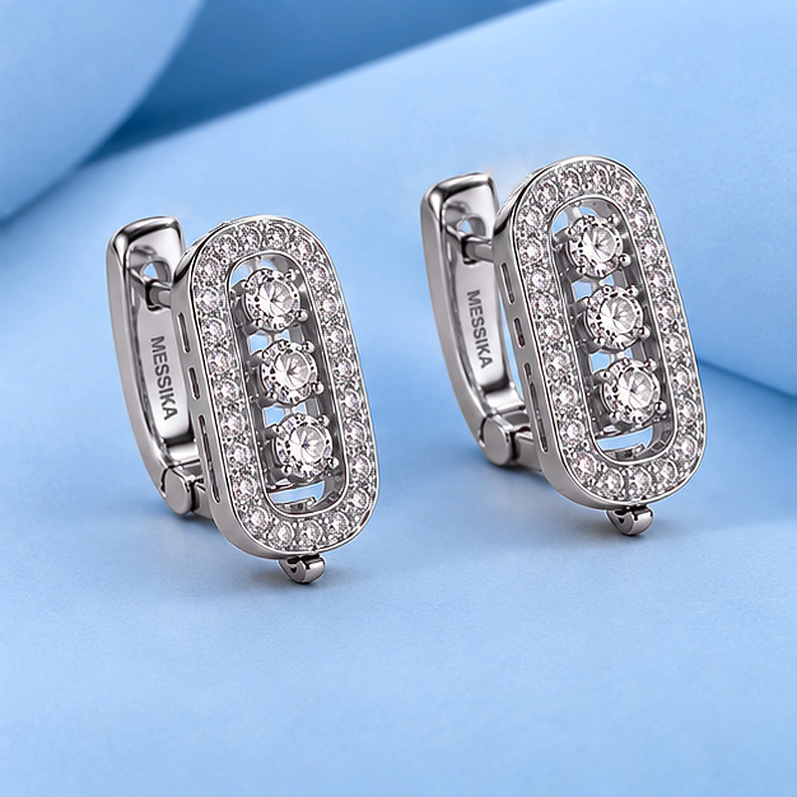 Gold earrings with diamonds in the style of messika