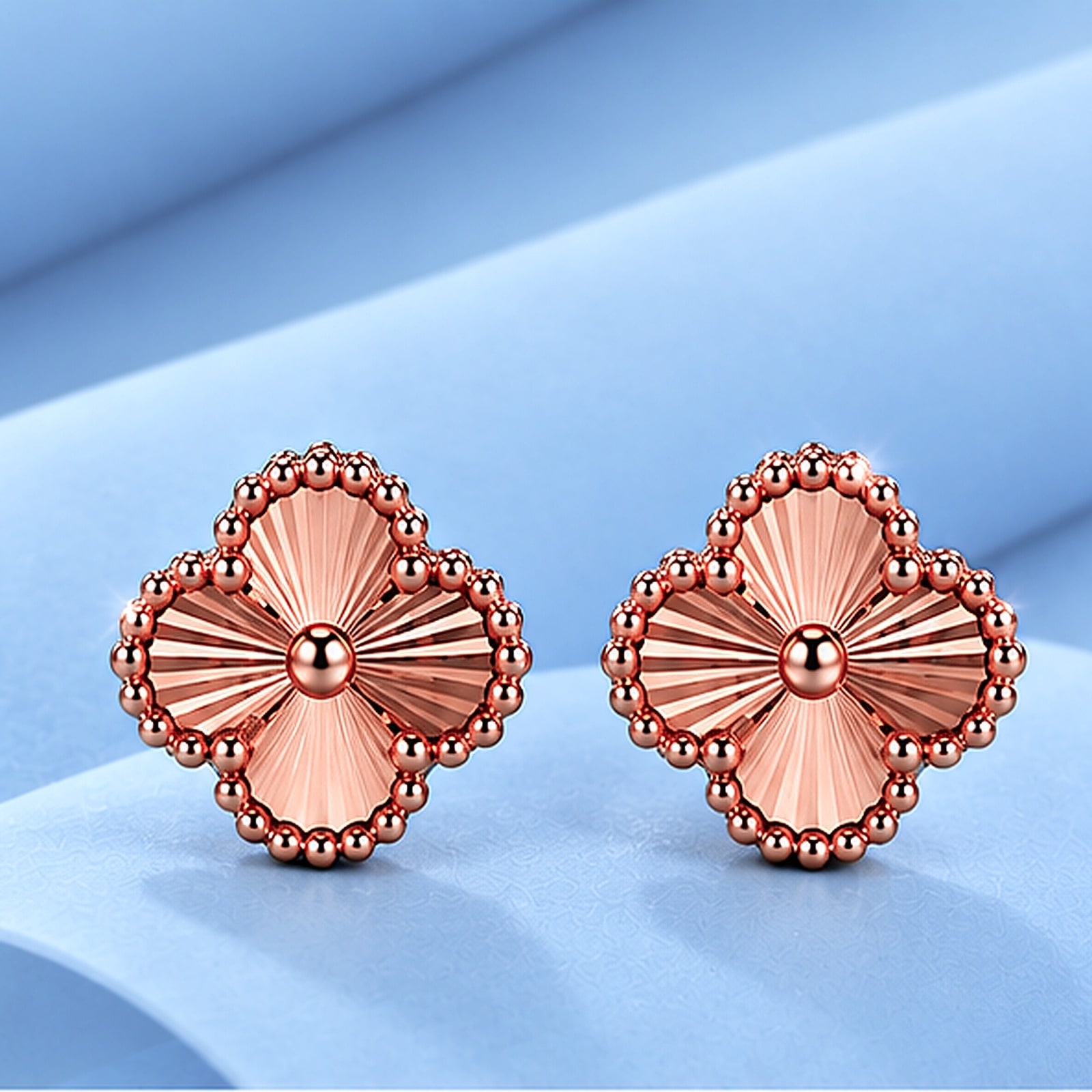 Gold earrings in the style of van cleef