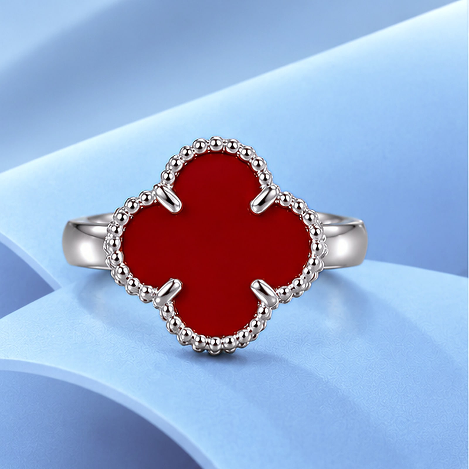 Gold ring with carnelian in the style of van cleef