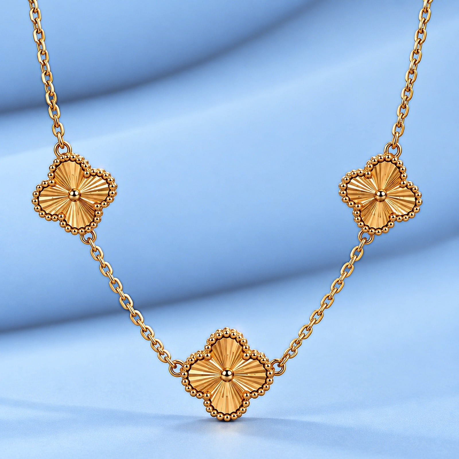 Gold necklace in the style of van cleef