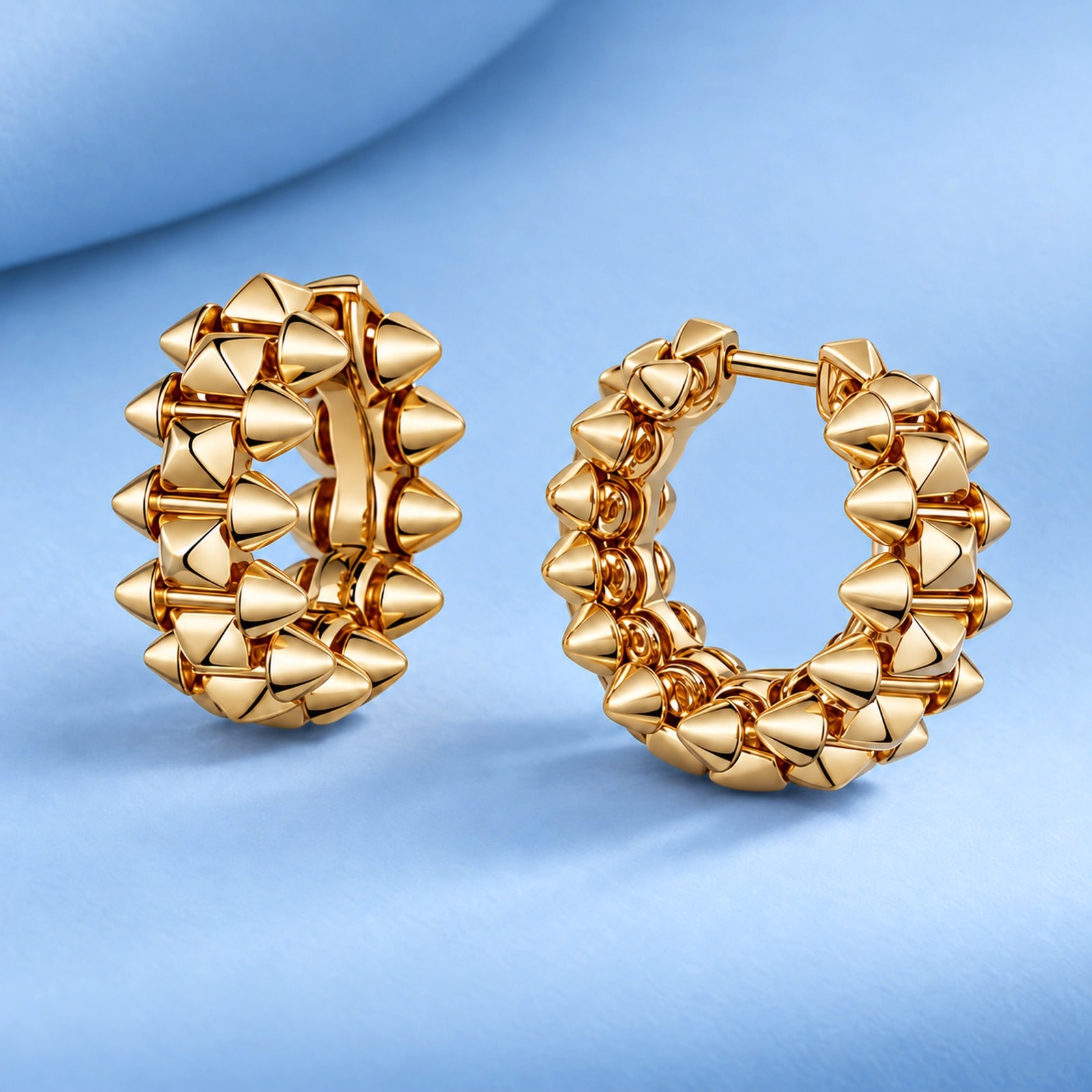 Gold earrings in the style of cartier