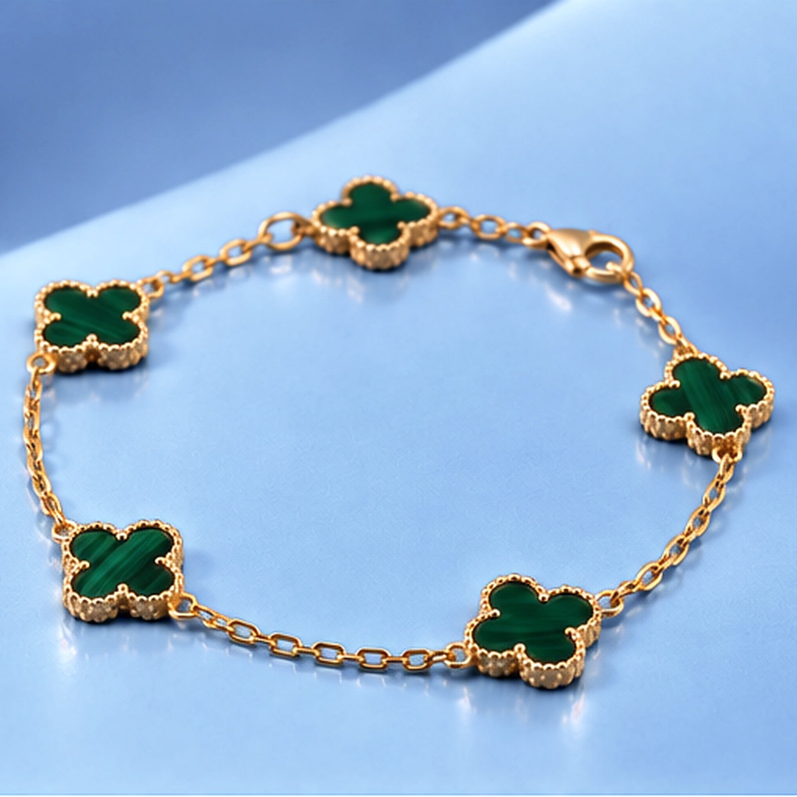Gold bracelet with malachite in the style of van cleef