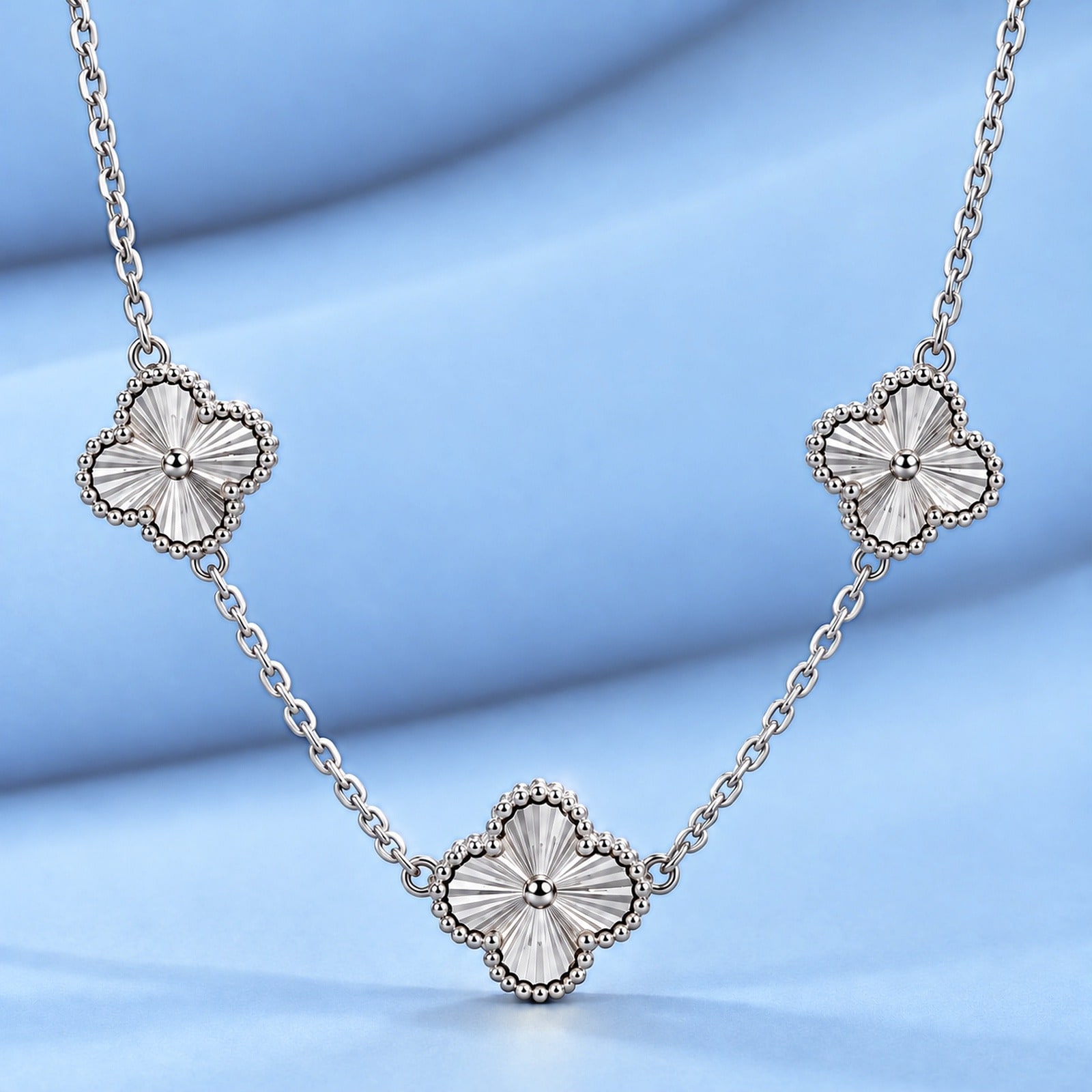 Gold necklace in the style of van cleef